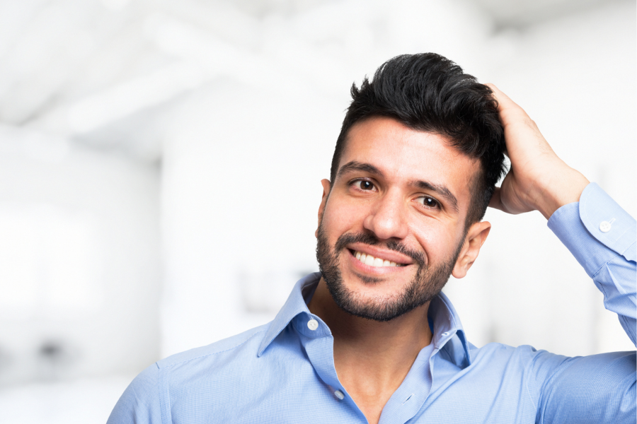 Man feeling the back of his head
