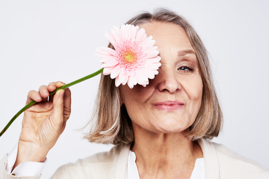 Elderly woman holding flower