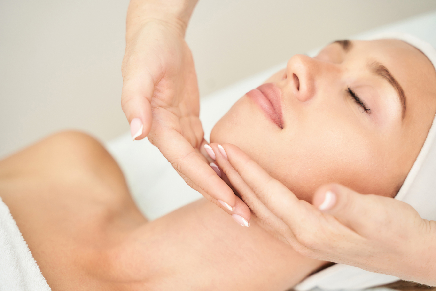 Woman receiving Epionce Facial treatment laying down